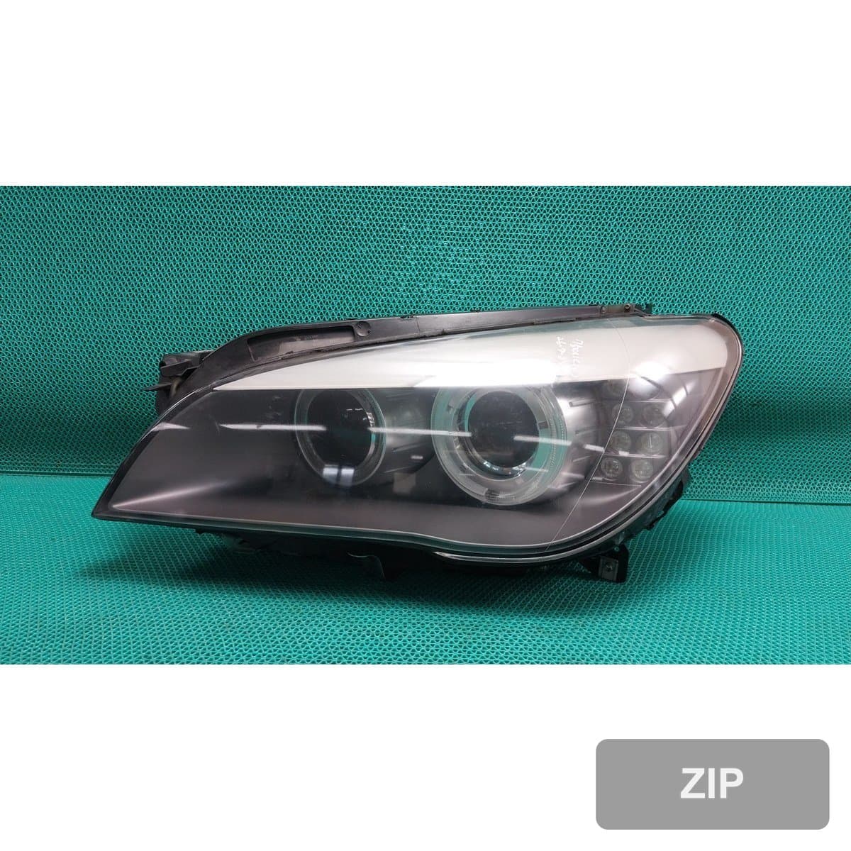 BMW 750Li 2010 — фара левая (водительская) 7182137